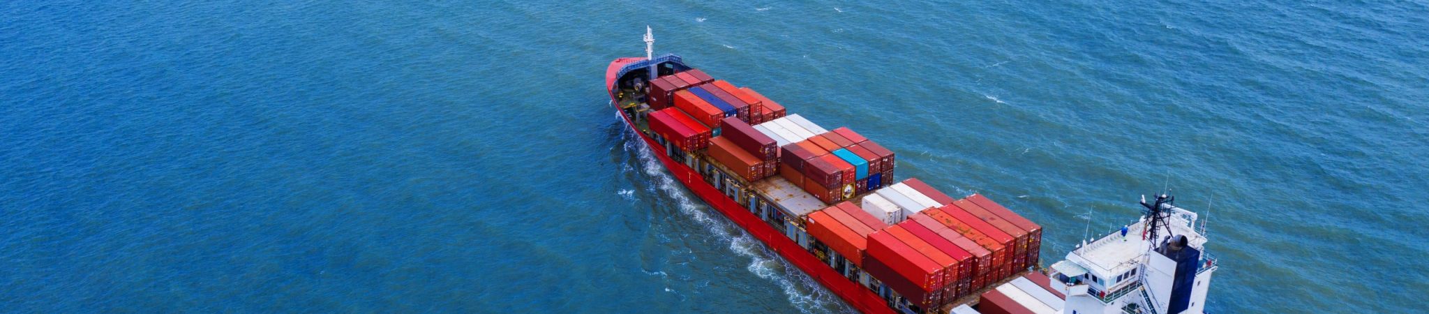Aerial view of container cargo ship in sea.